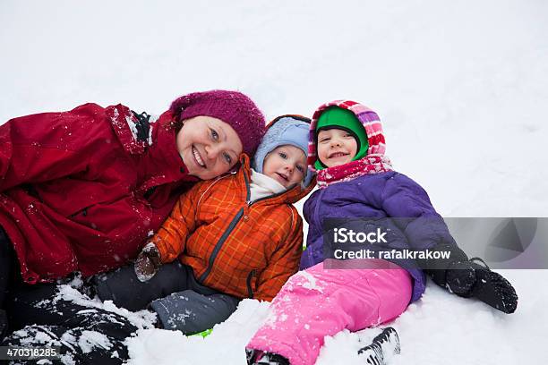 Mom With Children Play On Snow Stock Photo - Download Image Now - 12-17 Months, 4-5 Years, Adult