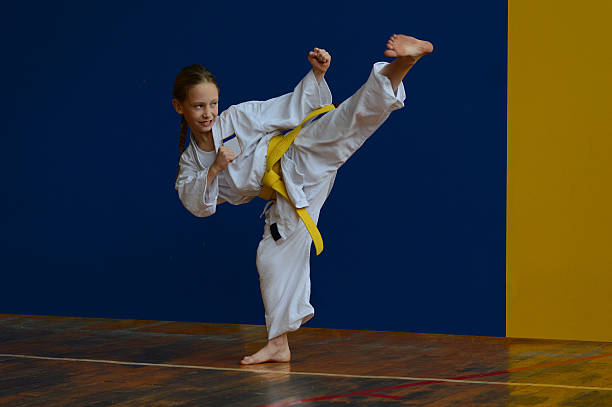 Yoko gery Young girl in Carate training yellow belt stock pictures, royalty-free photos & images