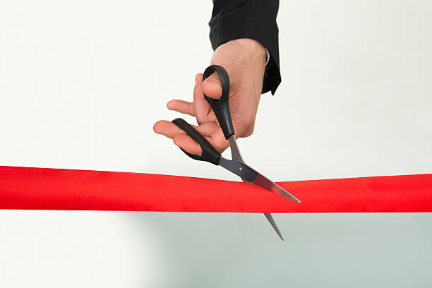 istock Businessman Cutting Red Ribbon With Scissors 470319212