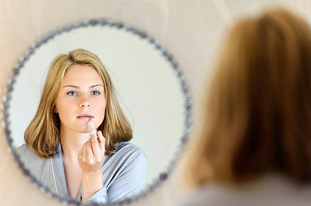 istock Beautiful young woman doing make-up 470321176