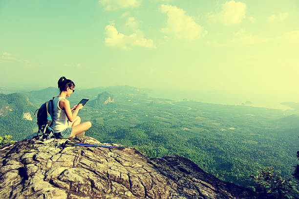 istock hiking woman use digital tablet on mountain peak 470321428