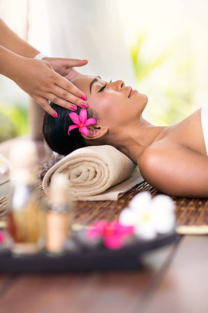 istock young woman receiving head massage 470321952