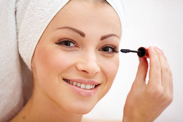 istock Closeup of a smiling young female applying eye shadow 470323793