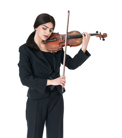 studio portrait of a violinist with long hair on a black background