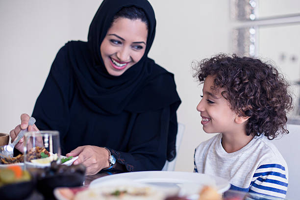 istock Middle Eastern mother serving food to her son 470325470