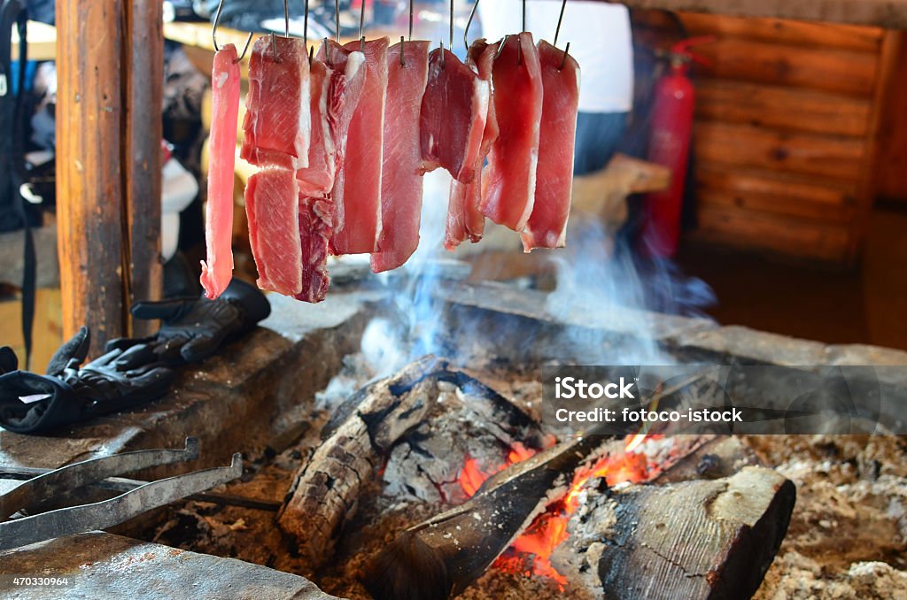 Fresh meat in smoke Fresh pork meat over fire in fireplace, traditional way of meat conservation by smoking and drying Beech Tree Stock Photo