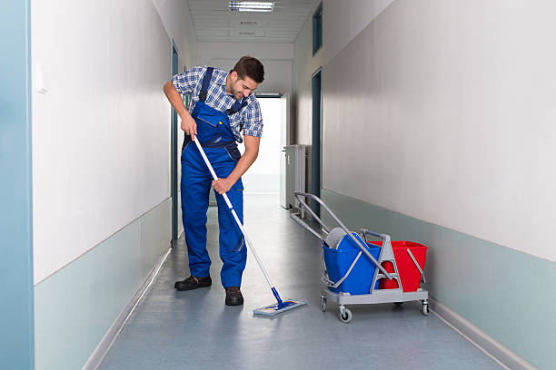 istock Male Worker With Broom Cleaning Office Corridor 470331218
