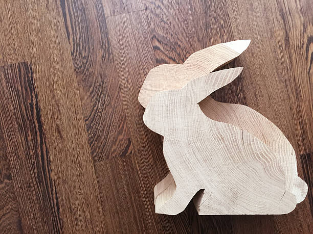 istock Two fresh cut diy oak rabbits on dark wooden background 470331896