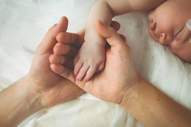 istock Mother and father holding her child's hand 470331958