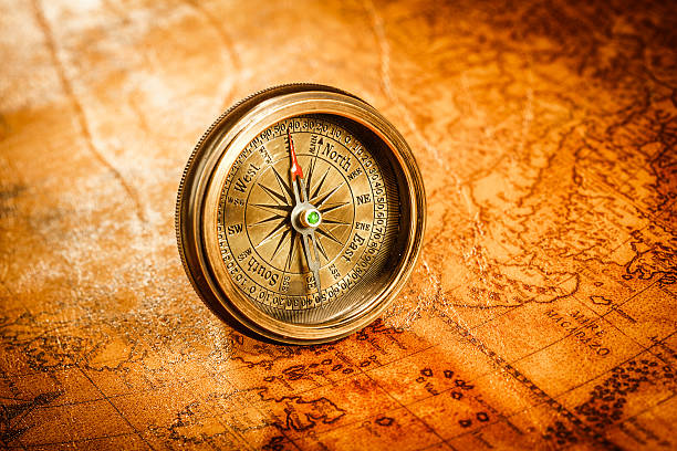 istock Vintage compass lies on an ancient world map. 470336694