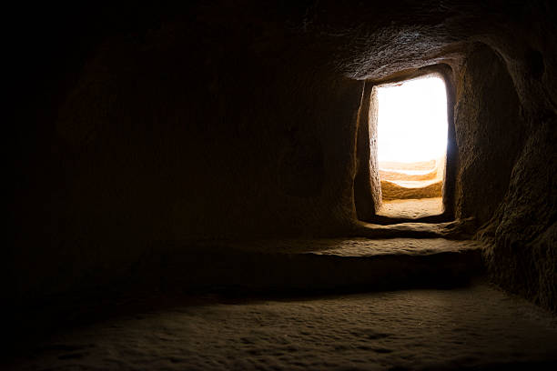 Doorway to light Bright sunlight outside the entrance to a room carved from stone centuries ago at Keşlik Monastery, in Turkey's Cappadocia region. tomb photos stock pictures, royalty-free photos & images