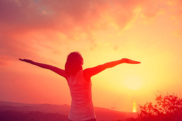 istock cheering woman on mountain peak 470339804