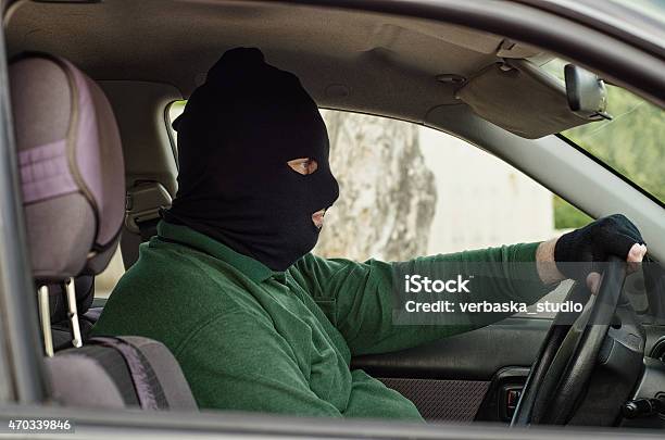 Robber In Balaclava Inside A Car Stock Photo - Download Image Now - Bank Robber, Car, 2015
