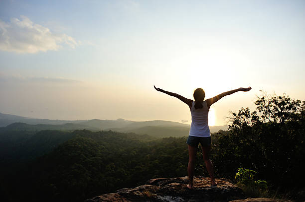 istock Female hiker with arms outstretched on mountain peak 470340230
