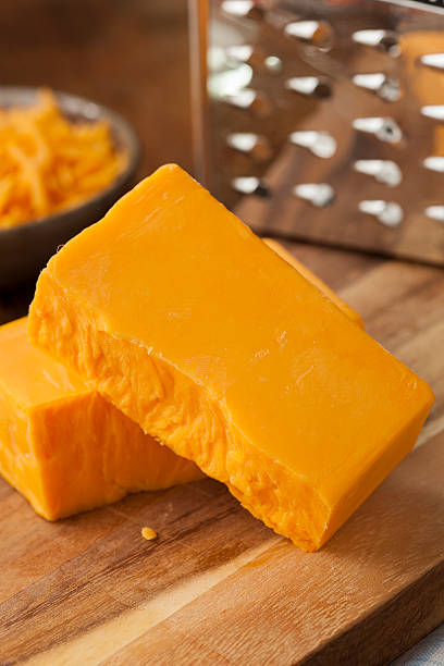 istock A large broken block of sharp cheddar cheese on wood 470341409