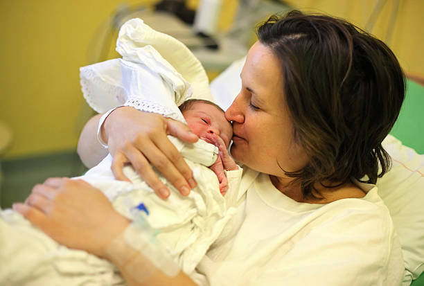 istock Mother cuddling with her newborn baby 470345967