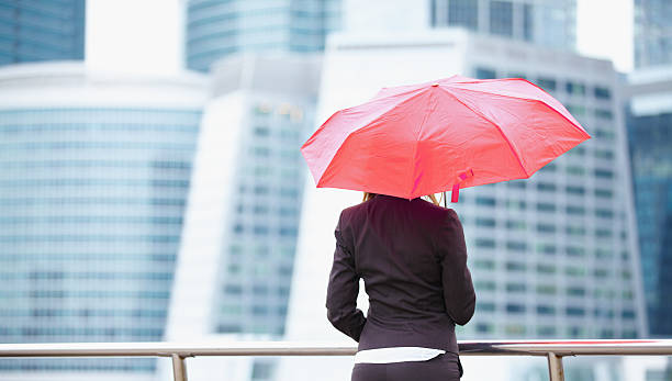 istock Young business woman with umbrella 470349971