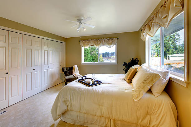 istock Light tones bedroom with a queen size bed 470350061