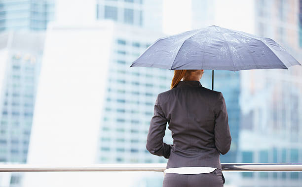 istock Young business woman with umbrella 470350081