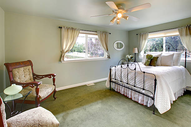 istock Olive tones bedroom with antique iron frame bed 470350157