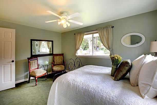 istock Olive tones bedroom with antique iron frame bed 470350175
