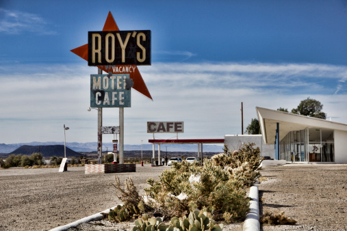 Amboy, United States - February 7, 2014: Partially abondoned tourist stop on the old Route 66 in the Mohave desert in California, about 50 miles north of Twentynine Palms.  The gas station is still in operation and the cafe only sells cold drinks.   The iconic 