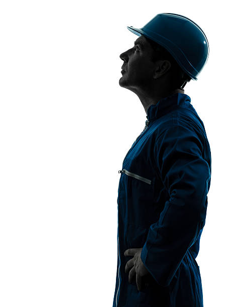 istock man construction worker looking up profile silhouette portrait 470350929