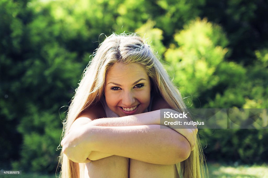 young woman in the park young woman in the park, sitting on the grass. Adult Stock Photo