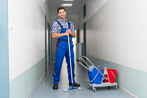 istock Happy Male Worker With Broom Cleaning Office Corridor 470351458