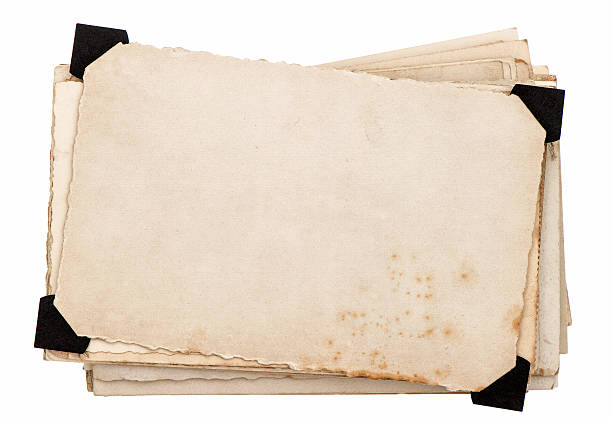 istock Old grungy paper with black plastic corners 470353423