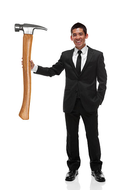 istock Businessman holding a gaint hammer to the side 470354060