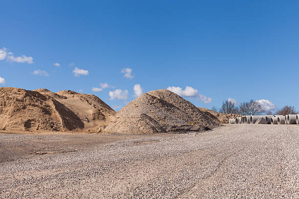 istock Piles of Gravel at Construction Site under Bright Blue Sky 470355266