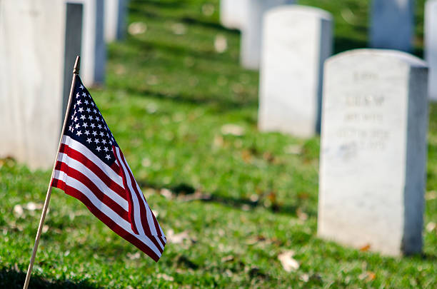 istock American flag in a cemetery 470355844