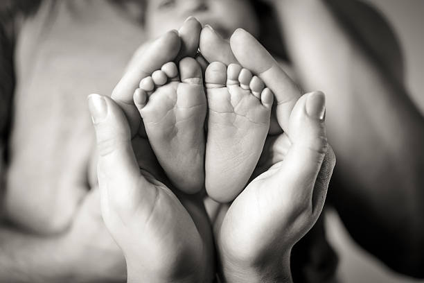 Parents holding baby's feet