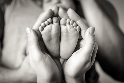 Parents holding baby's feet