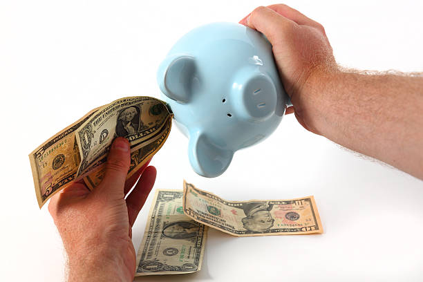 istock Emptying piggy bank 470357263