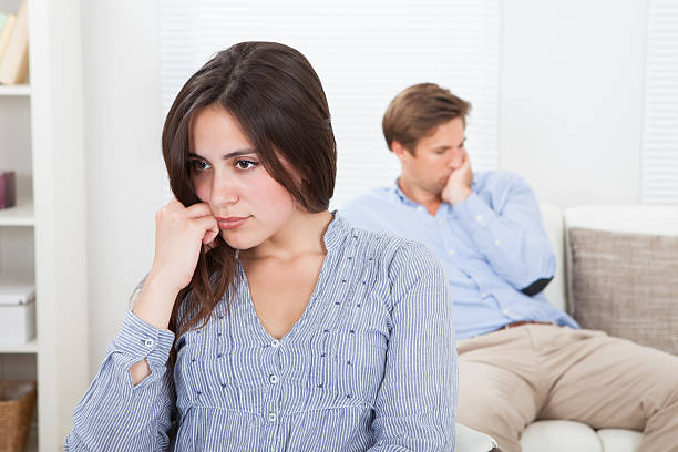 istock Upset Woman With Man Sitting On Sofa In Background 470359144