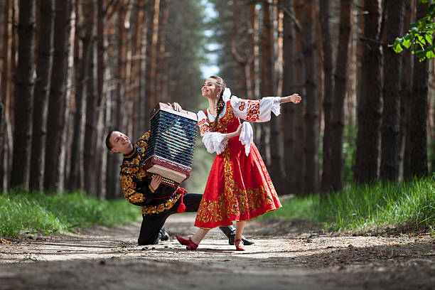 Couple dancing in russian national dress stock photo