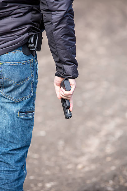 istock Close-Up of Man Holding .45 Caliber Handgun 470364348