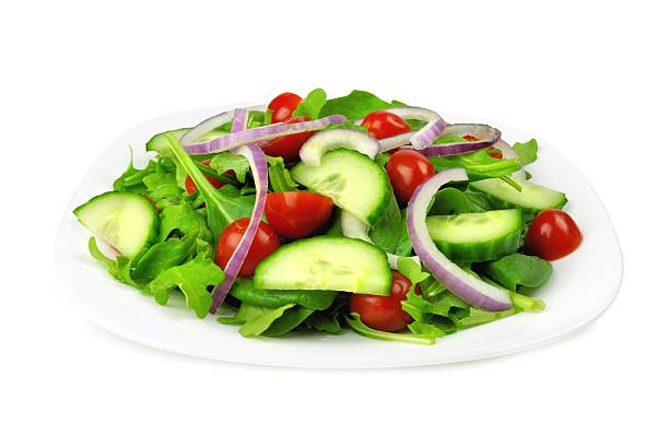 istock Garden salad on plate, isolated on white 470369898