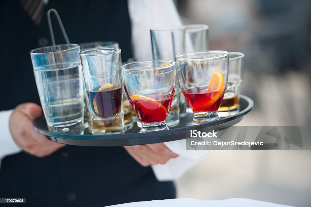 Waiter serving alcohol Serving Tray Stock Photo