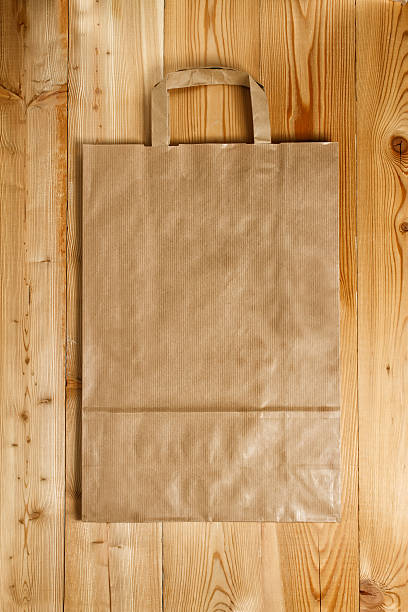 istock Paper bag on a wooden texture 470372672