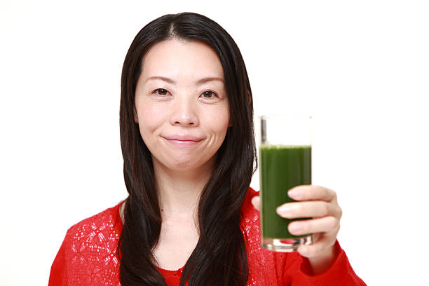 istock woman with green vegetable juice 470372880
