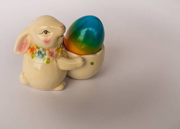 istock Easter bunny with a basket with painted colorful egg 470373156