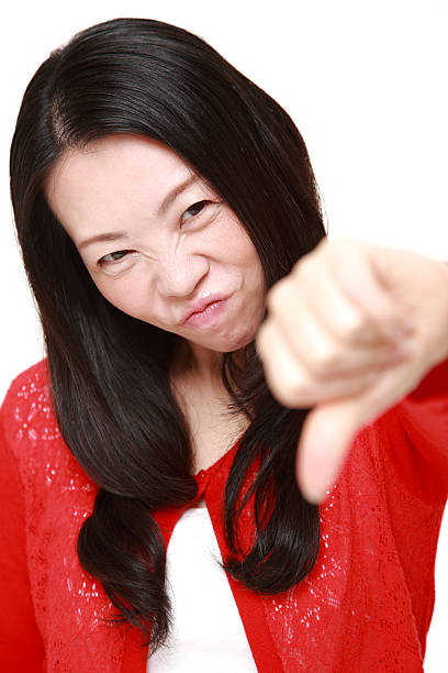 istock woman with thumbs down gesture 470375306