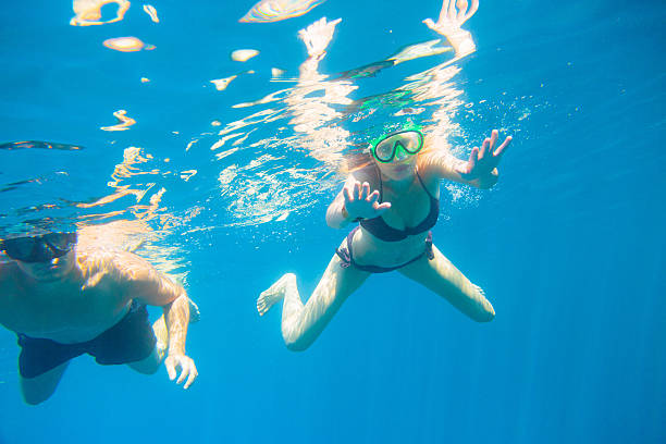 istock young couple snorkeling 470378435