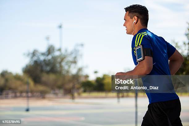 Athletic Man Running With Music Stock Photo - Download Image Now - Jogging, Men, In-ear Headphones