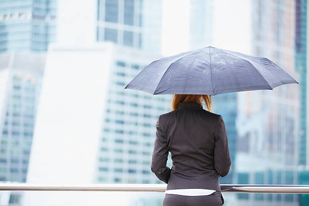 istock Young business woman with umbrella 470379393