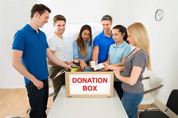istock People Putting Cans In Donation Box 470380724
