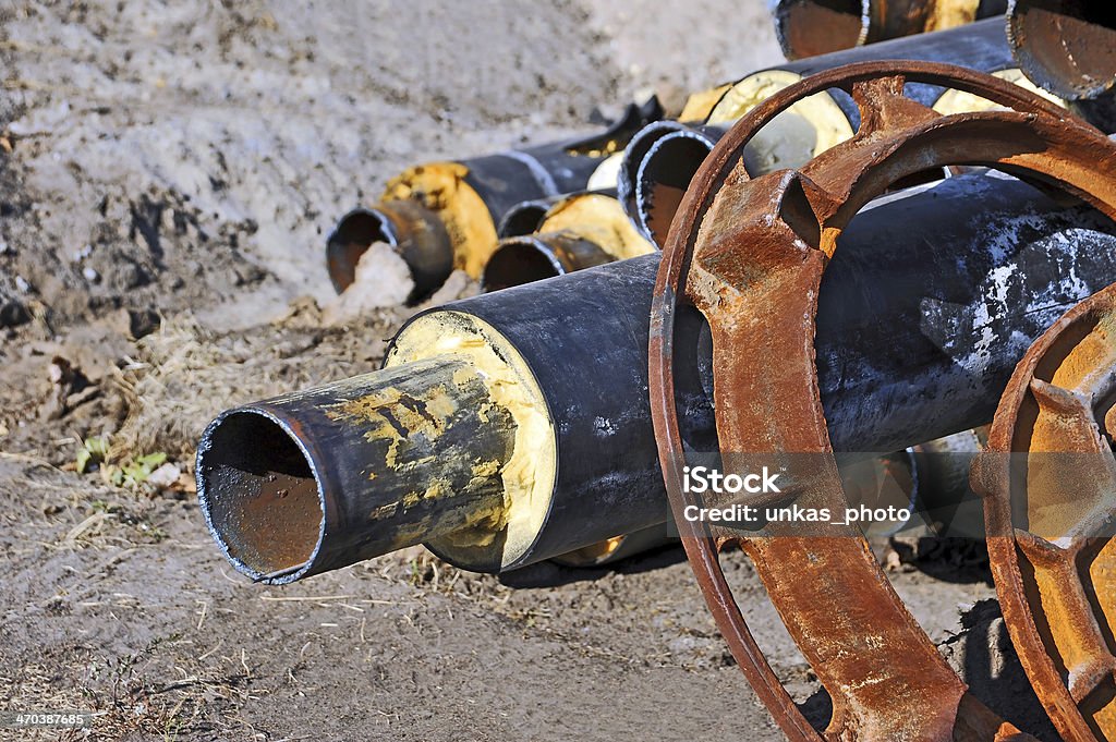 Rusty steel pipe with heat insulation Rusty steel pipe with heat insulation on construction site Black Color Stock Photo